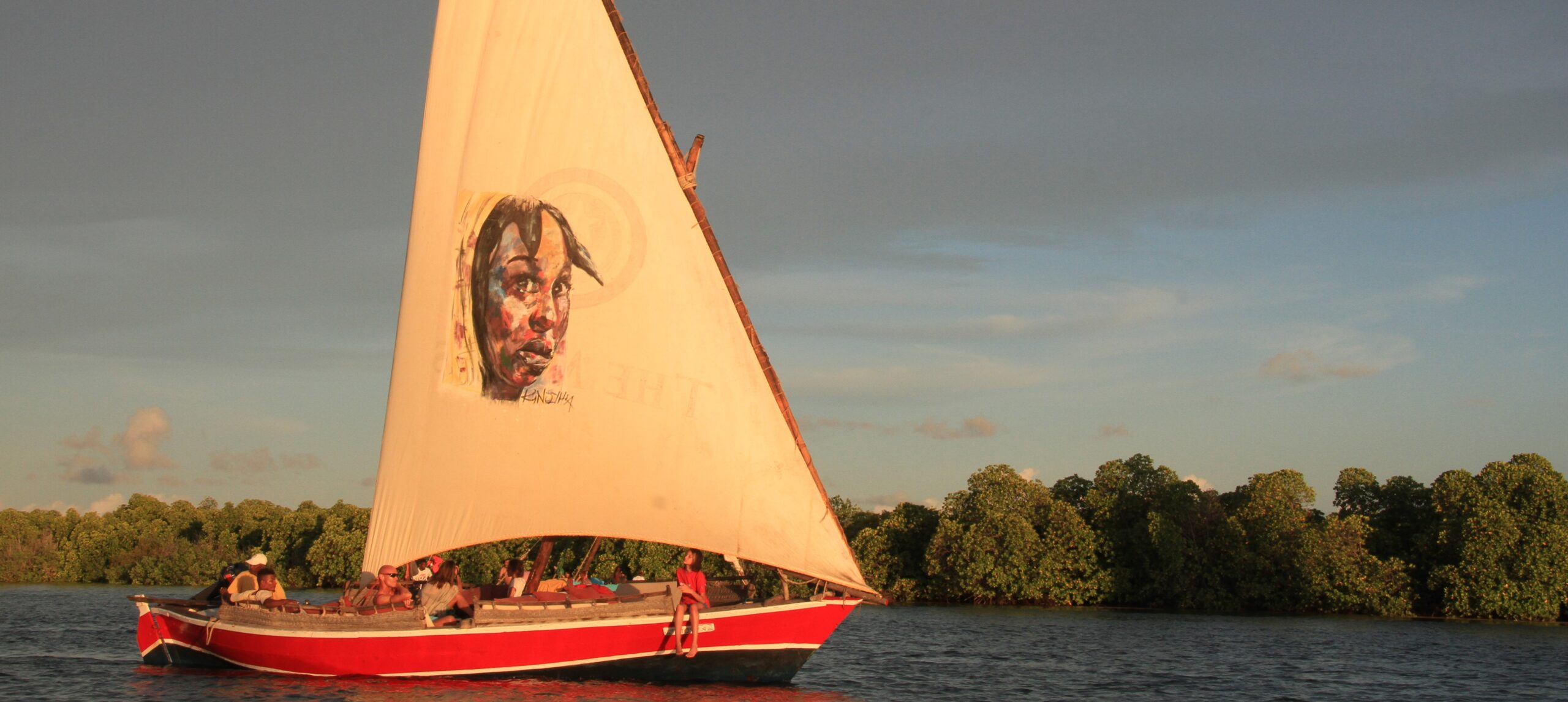 Red dhow under sail, painted face on the canvas